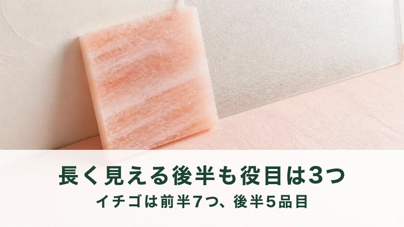白い壁に淡い桃色の四角い板を立てかけた