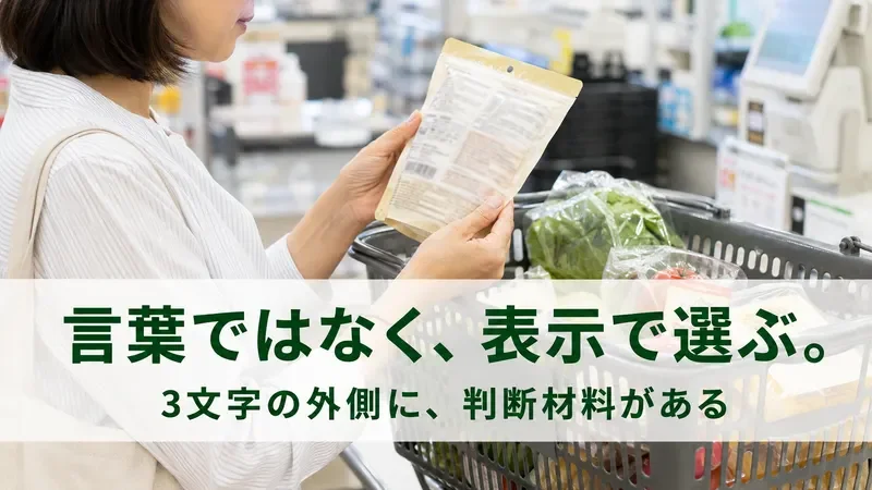 買い物かごの前で食品の袋を裏返して表示を確かめる女性