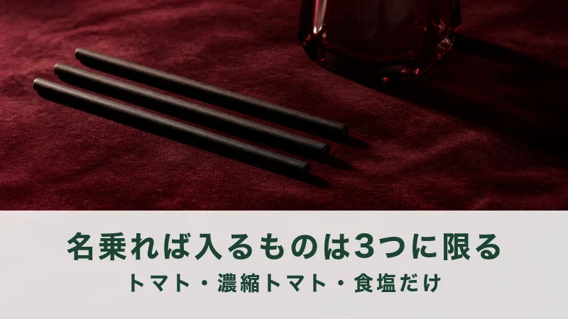 赤い布の上に細い黒い棒を3本並べた