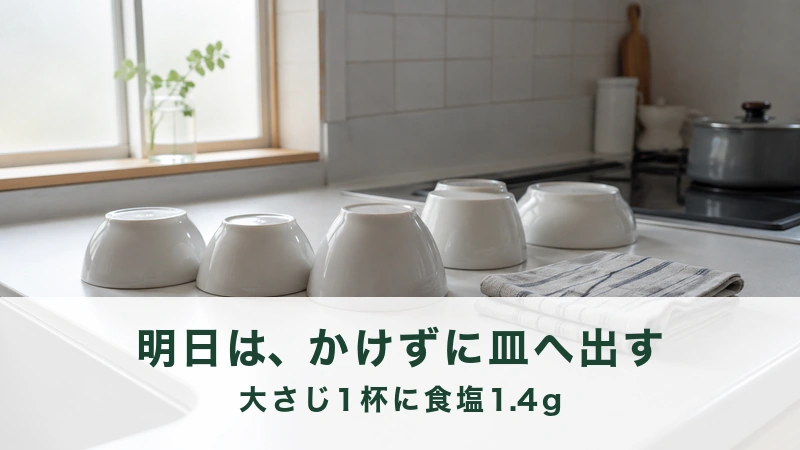 明るい台所の作業台に伏せて並べられた白い器とふきん