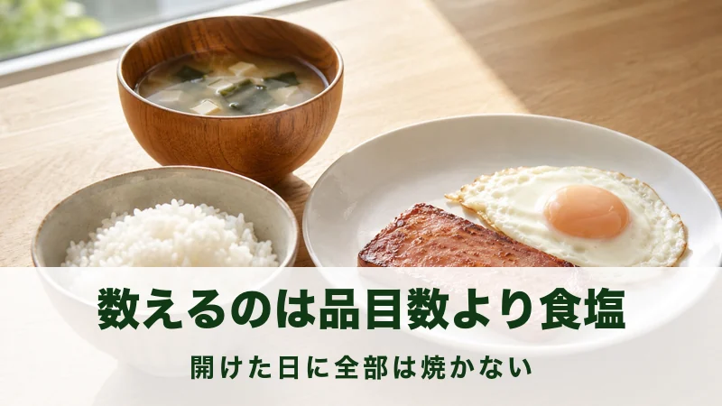 朝の食卓に焼いた肉一切れと目玉焼きとごはんが並ぶ