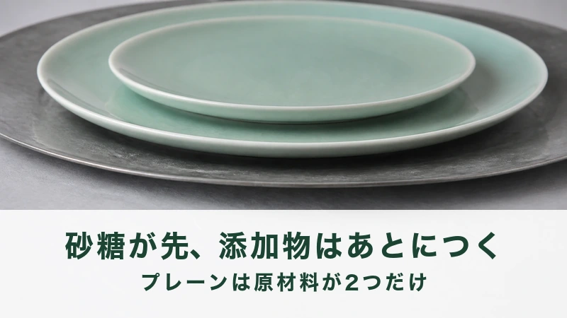 黒い金属の丸盆に淡い緑の皿を2枚重ねた