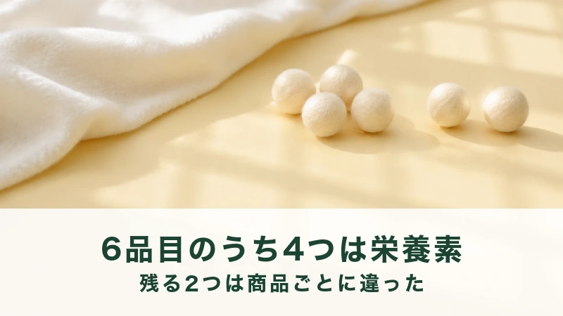 黄色い台の上に白い毛玉が5つと2つに分かれて置かれ、左に白い布がかかる